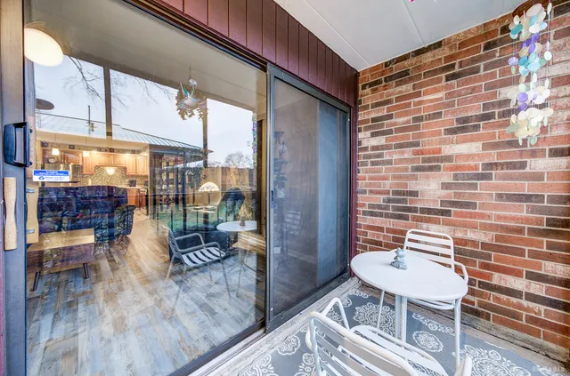 a balcony with chairs and wooden floor