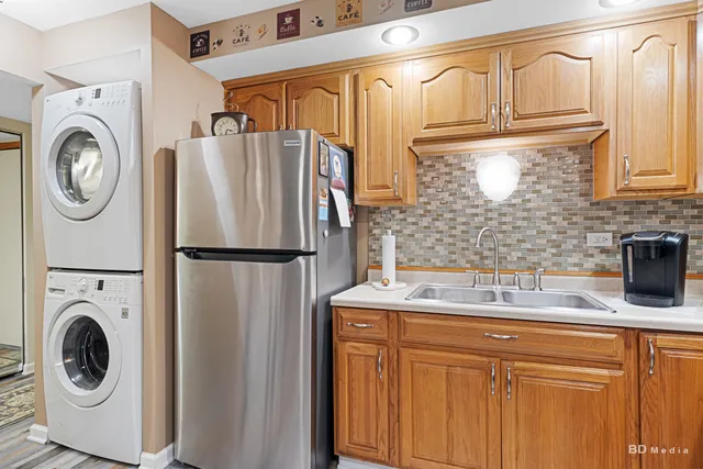 a kitchen with stainless steel appliances granite countertop a refrigerator and a sink