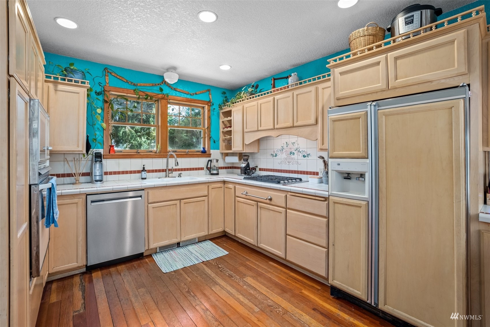 1295 Ferrier Road Winlock, WA 98596 - Photo 5 of 39 a kitchen with granite countertop cabinets stainless steel appliances a sink and a large window