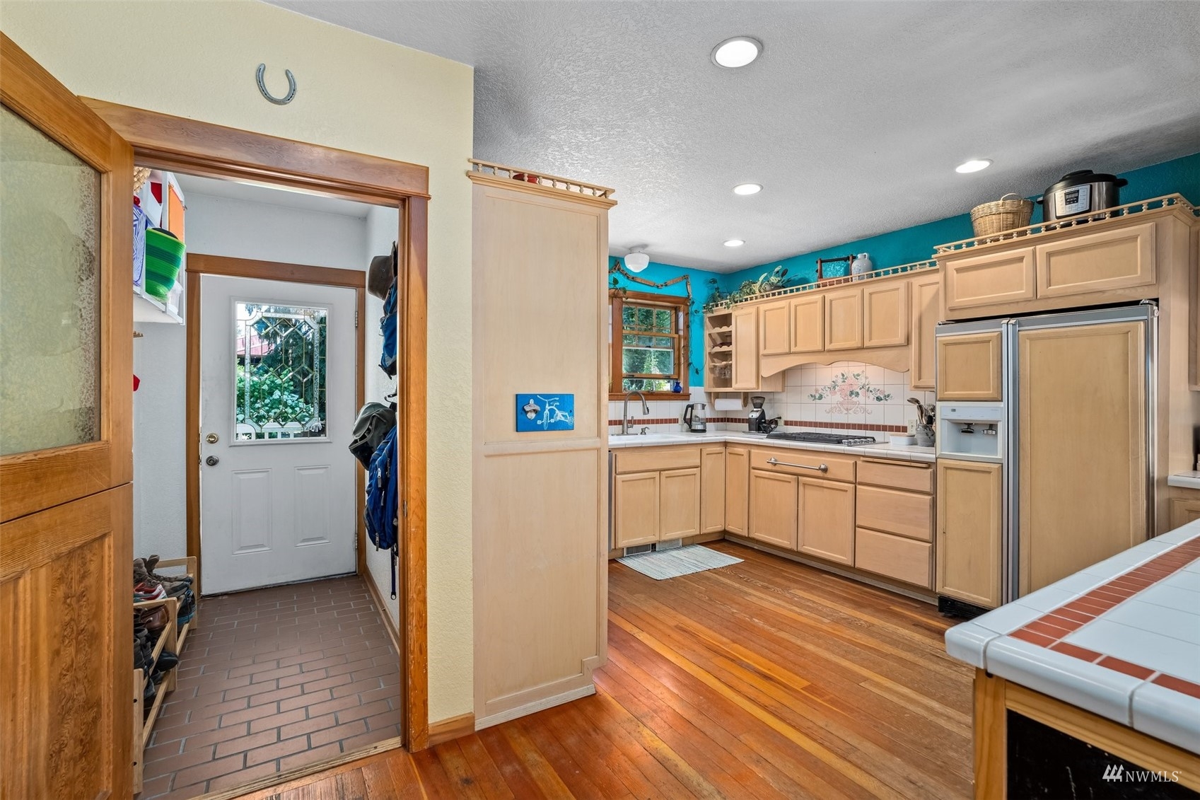 1295 Ferrier Road Winlock, WA 98596 - Photo 7 of 39 a kitchen with refrigerator cabinets and wooden floor