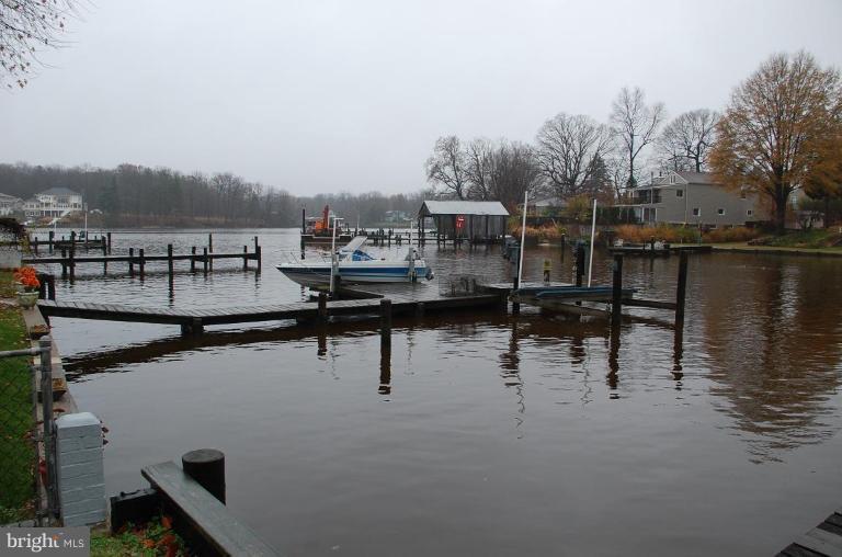 334 Wye Road Essex, MD 21221 - Photo 1 of 7 a view of a lake with boats and trees in the background