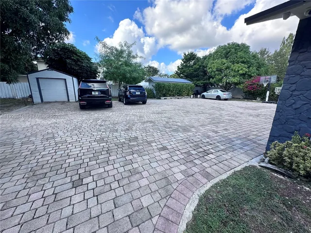 a view of house with truck parked