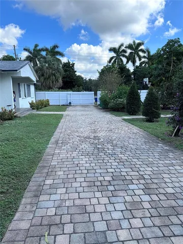 a view of a brick house with a yard