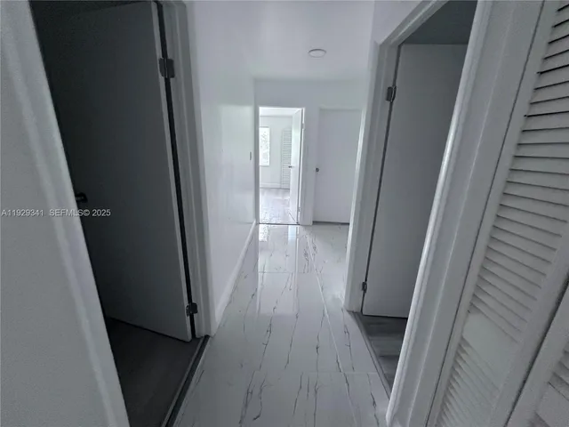 a view of a hallway and wooden floor