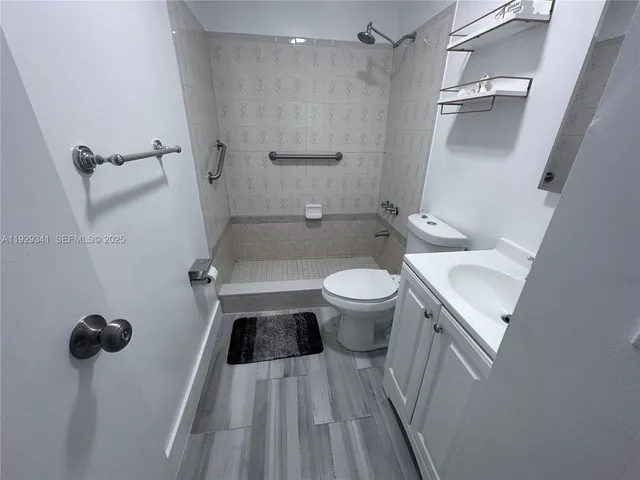 a bathroom with a sink toilet and shower