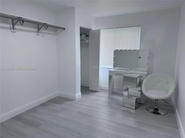 a workspace with wooden floor and a chair