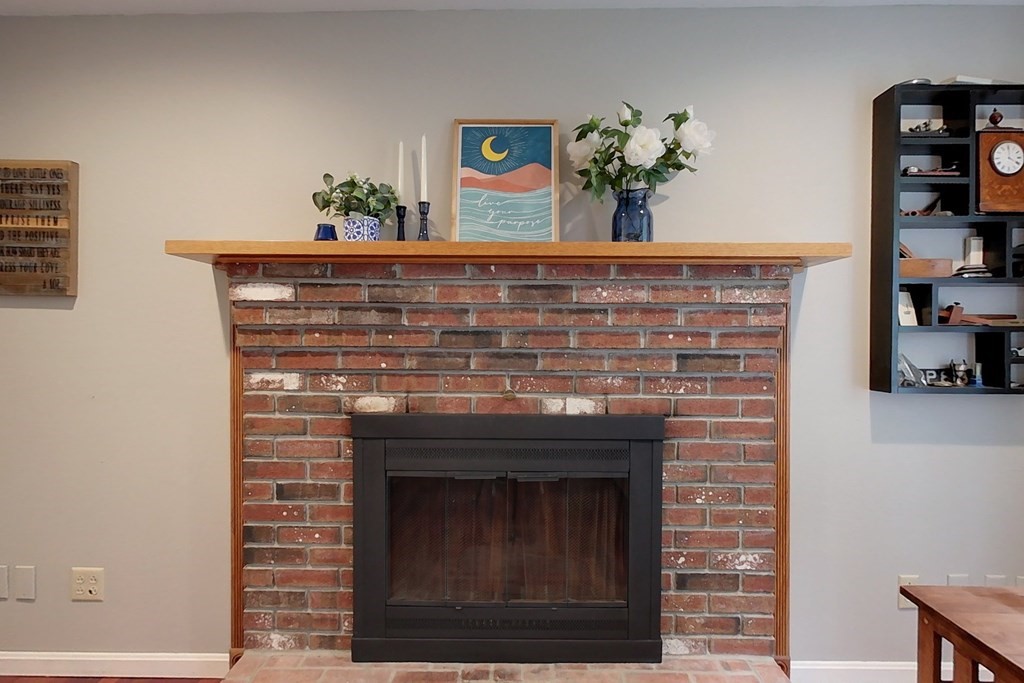 170 South Row Road Townsend, MA 01469 - Photo 11 of 42 a fireplace with vase and flowers on it