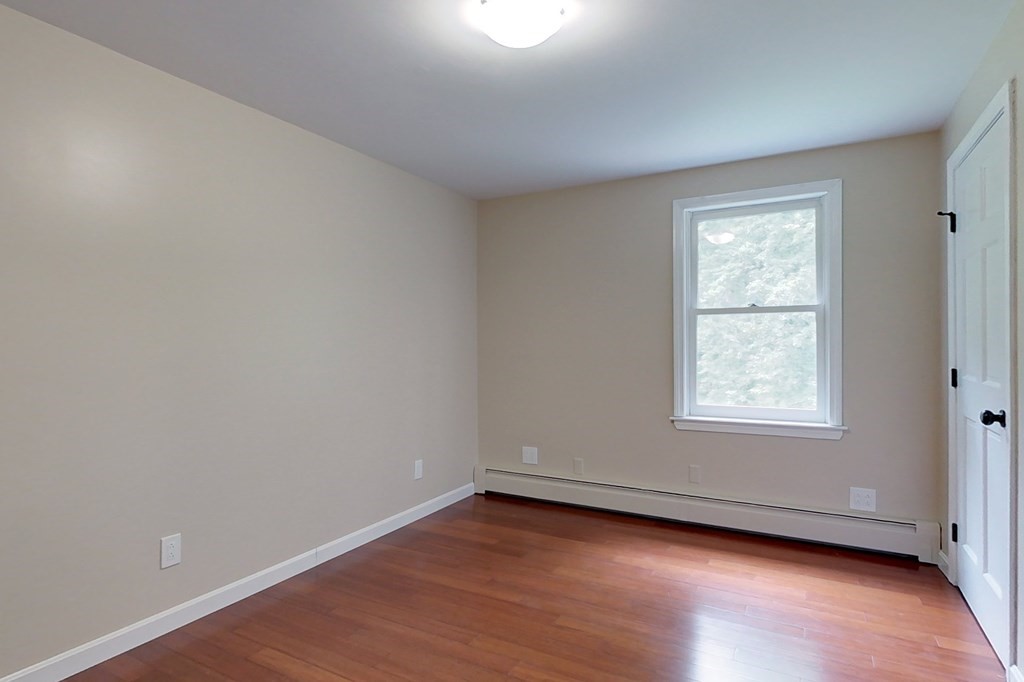170 South Row Road Townsend, MA 01469 - Photo 20 of 42 an empty room with wooden floor and window