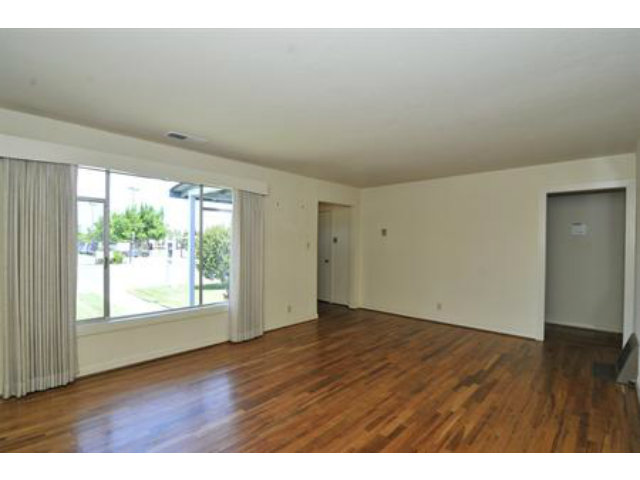 15308 Woodard Road San Jose, CA 95124 - Photo 2 of 10 an empty room with wooden floor and windows