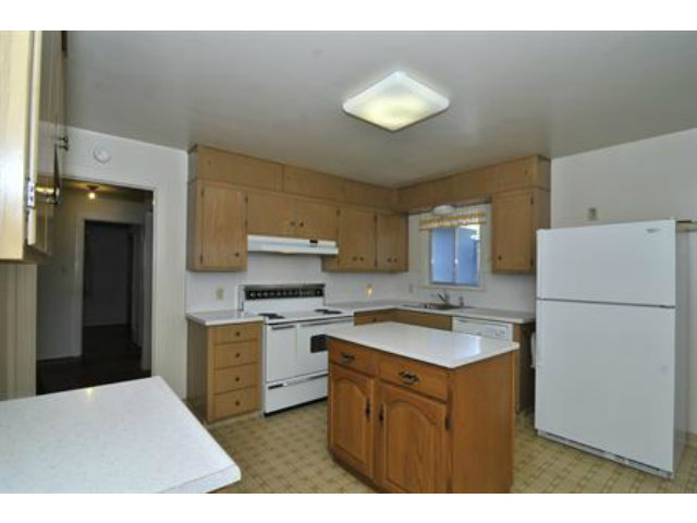 15308 Woodard Road San Jose, CA 95124 - Photo 4 of 10 a kitchen with a sink a stove a refrigerator and cabinets