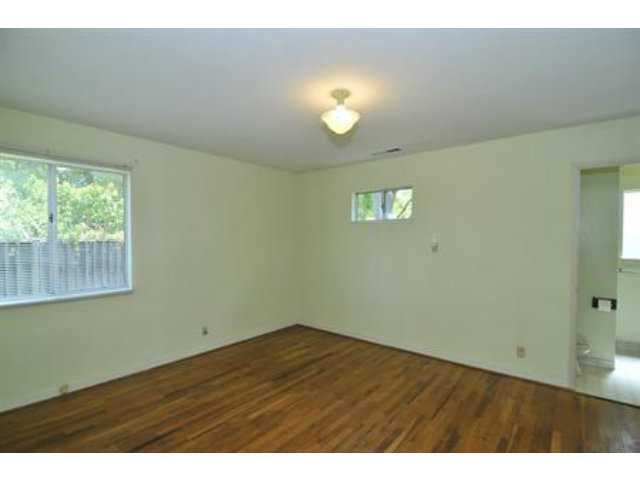 15308 Woodard Road San Jose, CA 95124 - Photo 5 of 10 a view of an empty room with wooden floor and a window