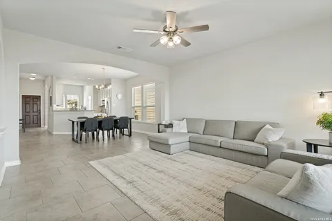 a living room with furniture and a chandelier