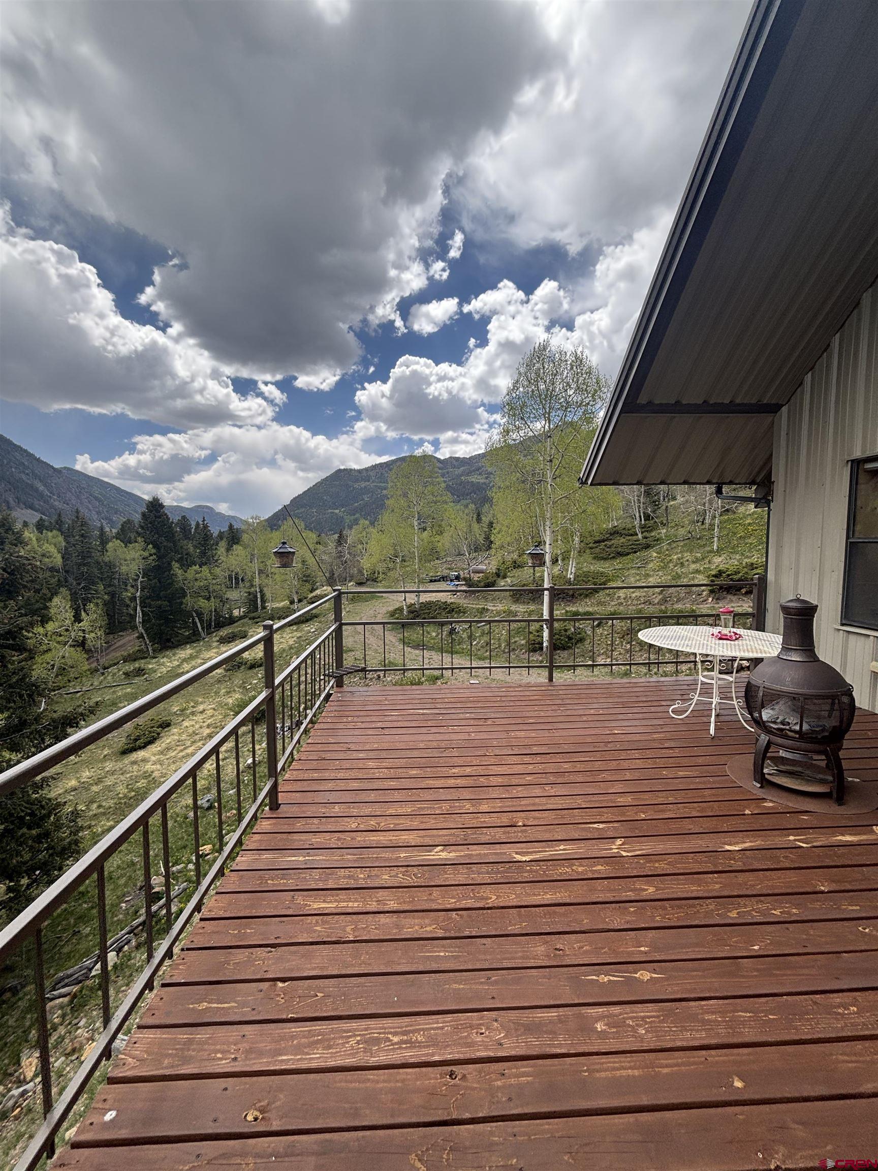 1113 Spring Street Del Norte, CO 81132 - Photo 39 of 43 a view of a balcony with floor to ceiling windows with wooden floor