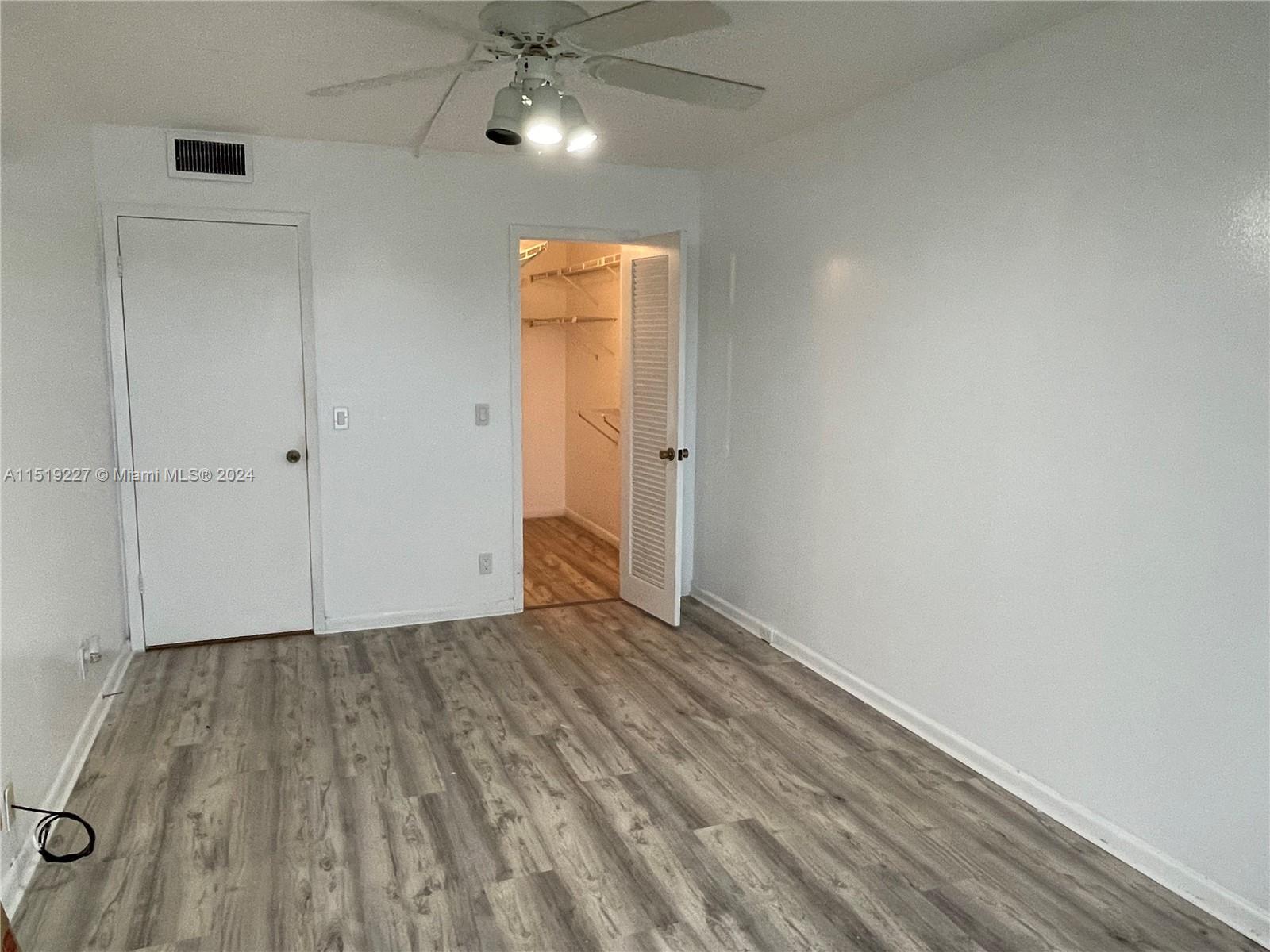 2085 Exeter, Unit 2085 Boca Raton, FL 33434 - Photo 11 of 31 a view of an empty room with wooden floor