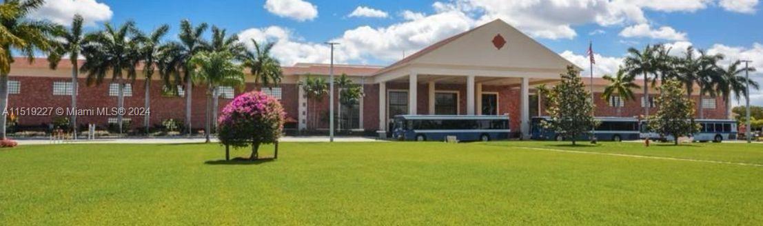 2085 Exeter, Unit 2085 Boca Raton, FL 33434 - Photo 31 of 31 a view of a house with a swimming pool and a yard