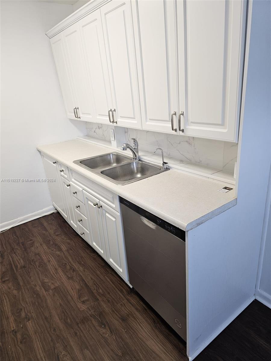 2085 Exeter, Unit 2085 Boca Raton, FL 33434 - Photo 7 of 31 a kitchen with a sink cabinets and a wooden floor