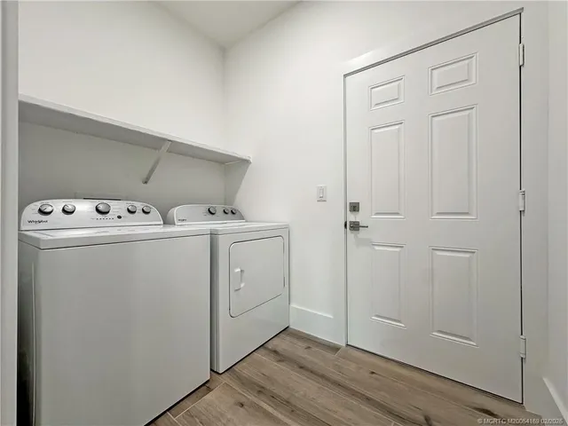 an empty room with wooden floor and a window