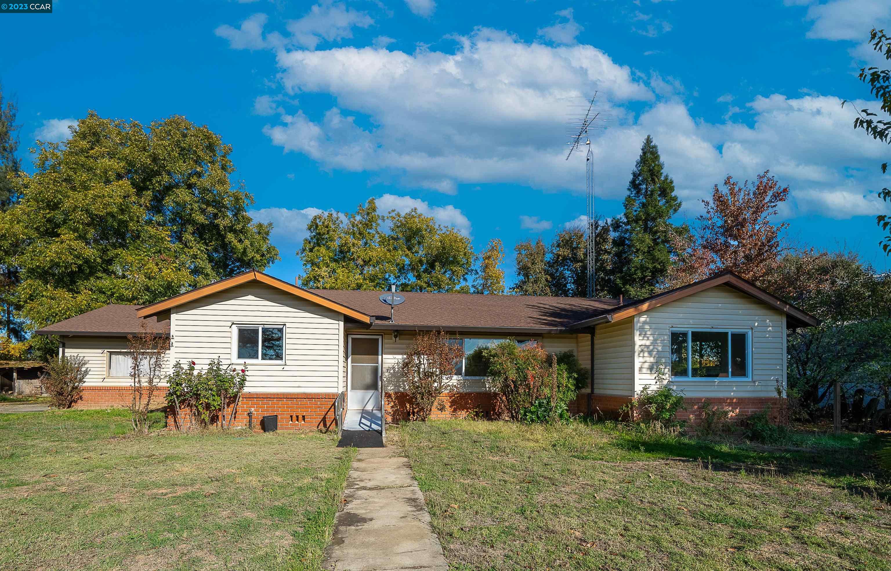 a front view of a house with garden