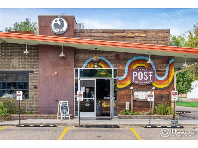 a patio with a table and chairs under an umbrella