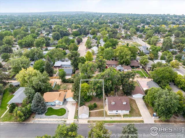 an aerial view of residential houses with outdoor space and street view