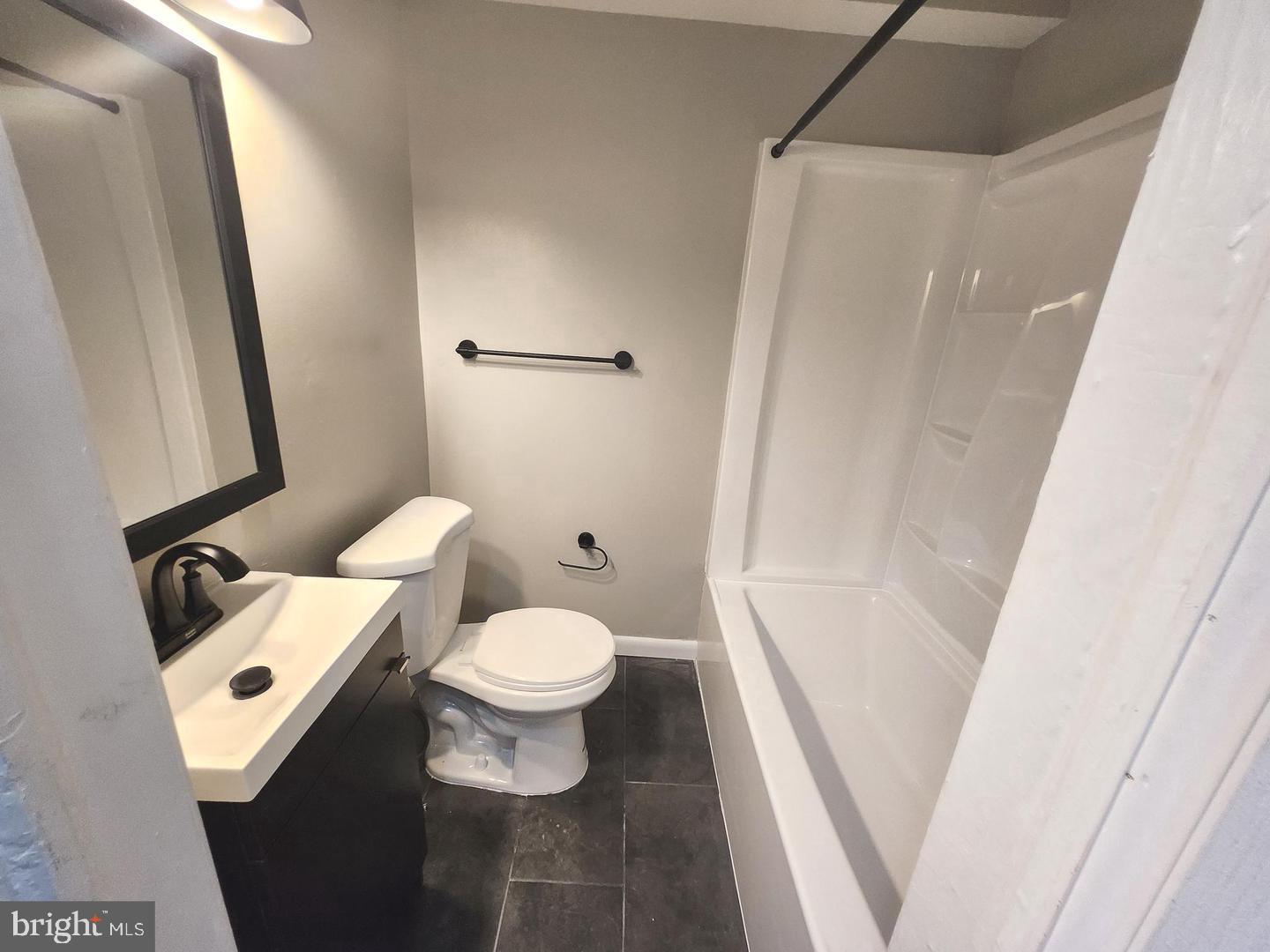 823 Stoll Street Brooklyn, MD 21225 - Photo 5 of 21 a white toilet sitting next to a bath tub