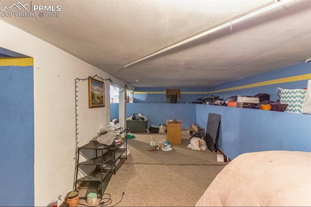 129 West 9th Street Walsenburg, CO 81089 - Photo 13 of 23 a bed room with furniture and a table