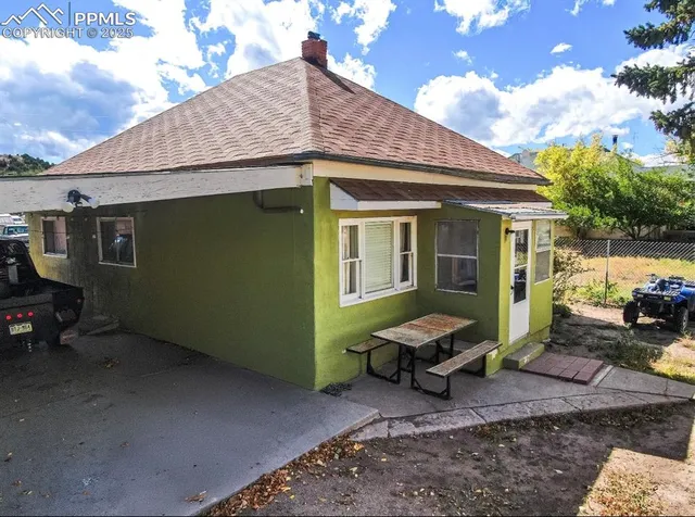 an aerial view of a house with garden space and sitting area
