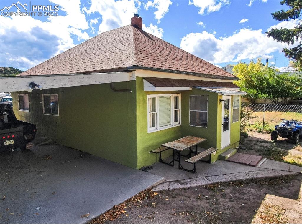 129 West 9th Street Walsenburg, CO 81089 - Photo 16 of 23 a view of a yard with a table and chairs under an umbrella