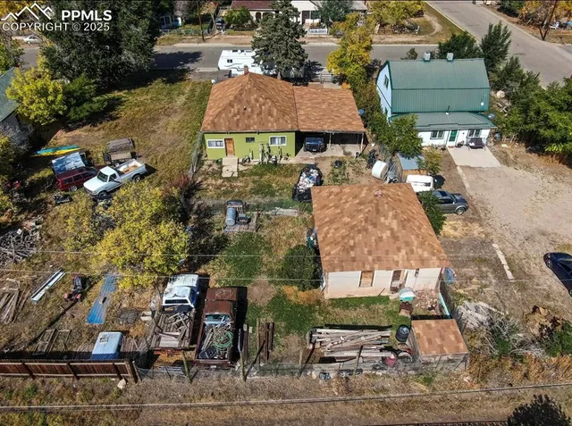 an aerial view of residential houses and car parked on street side