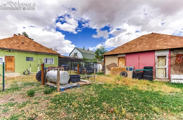 a front view of a house with a garden and yard