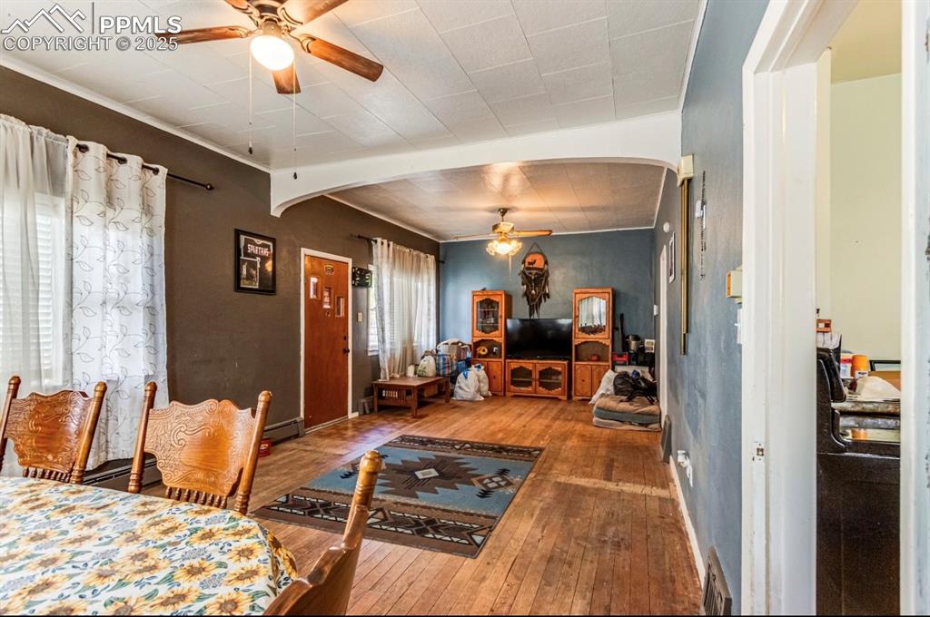 129 West 9th Street Walsenburg, CO 81089 - Photo 3 of 23 a living room with furniture and a chandelier