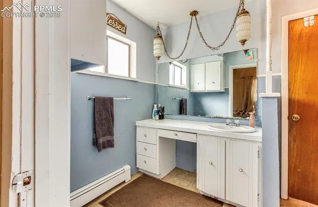 a kitchen with cabinets and wooden floor