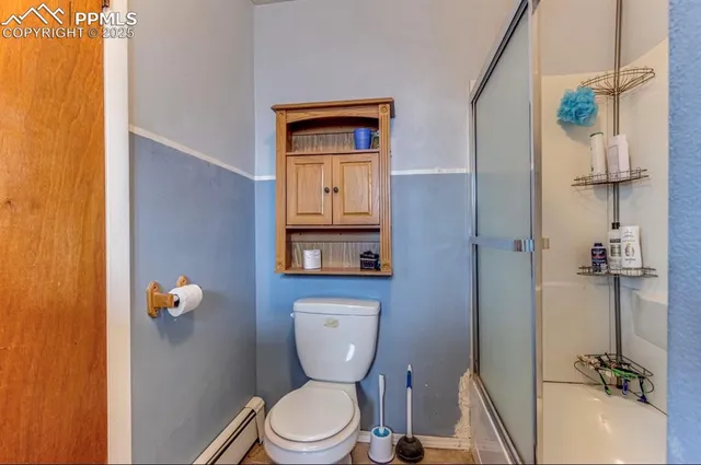 a bathroom with a toilet a sink and mirror