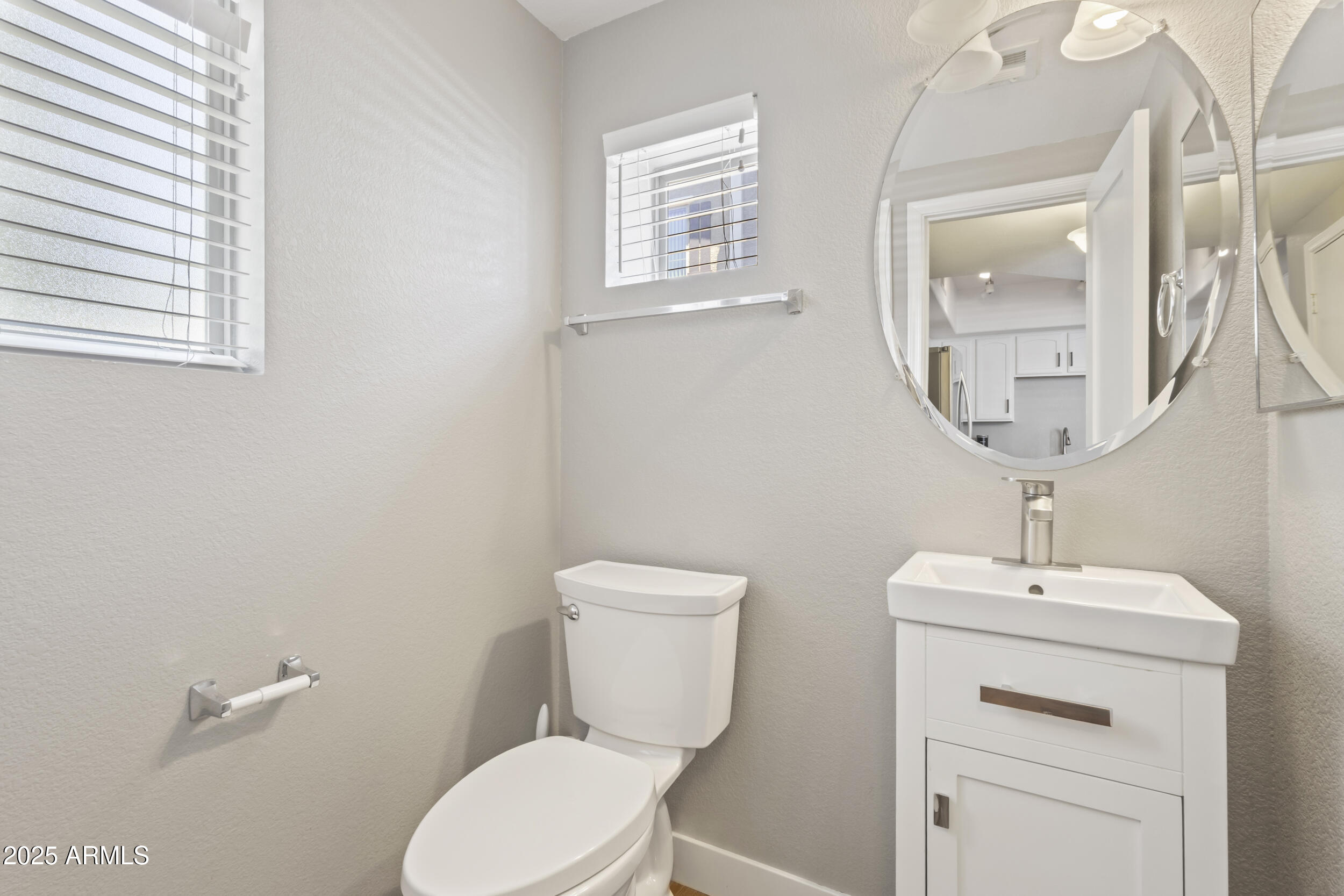 280 South Evergreen Road, Unit 1287 Tempe, AZ 85288 - Photo 13 of 28 a bathroom with a toilet a sink and mirror