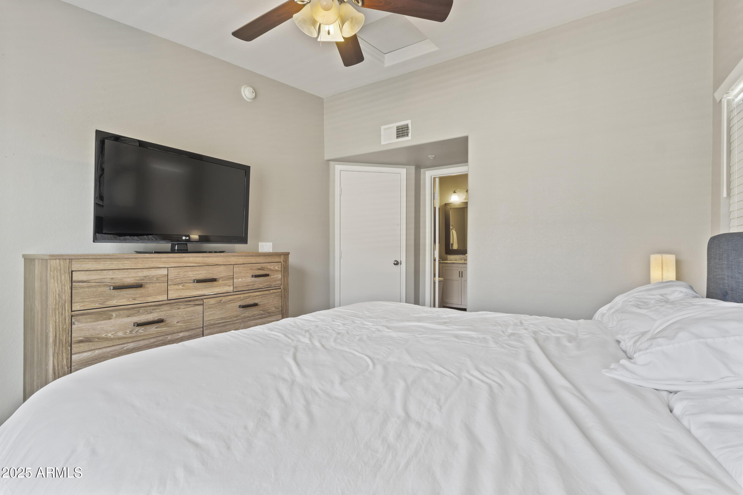 280 South Evergreen Road, Unit 1287 Tempe, AZ 85288 - Photo 17 of 28 a bedroom with a bed and a flat screen tv