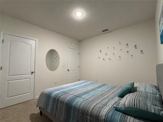 a bedroom with a bed and cabinets