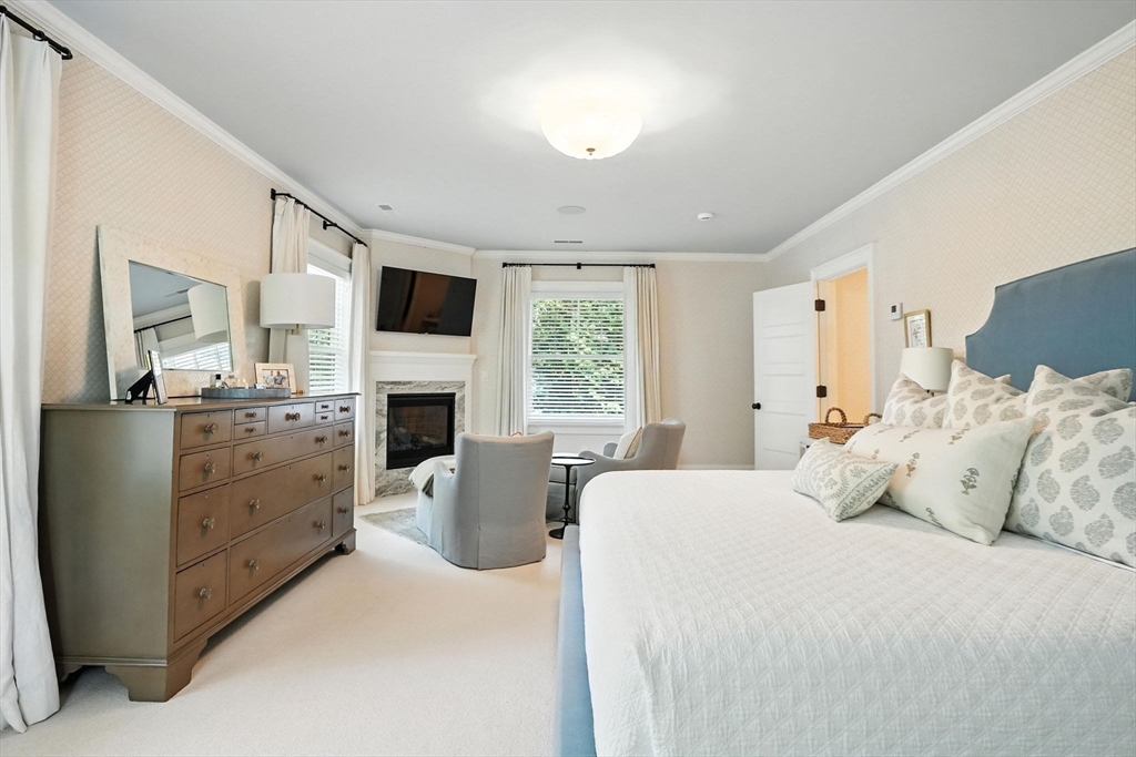 15 Winthrop Road Lexington, MA 02421 - Photo 25 of 39 a bedroom with a bed and a fireplace