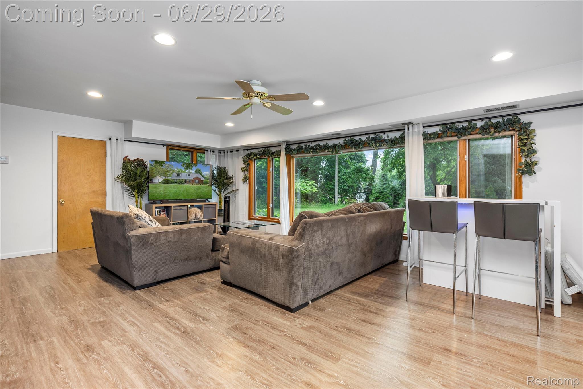 6085 Worlington Road Bloomfield Hills, MI 48301 - Photo 28 of 75 Spacious Family Room featuring wood-finish flooring, recessed lighting, a ceiling fan, and views of the Private Backyard