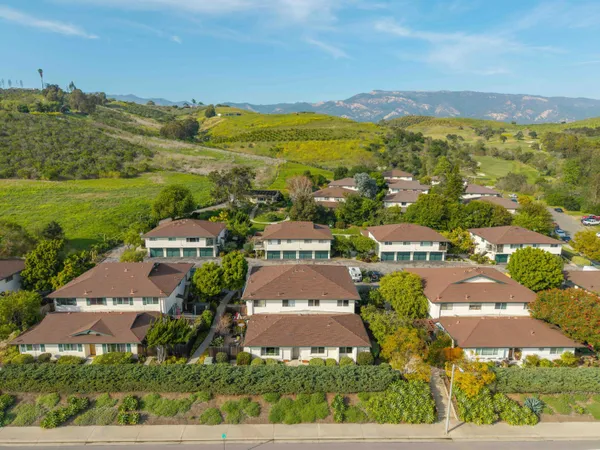 an aerial view of residential houses with outdoor space and street view