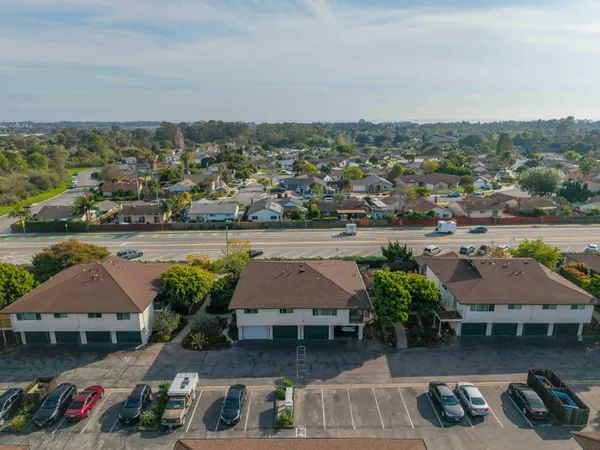 an aerial view of multiple houses with a lake view