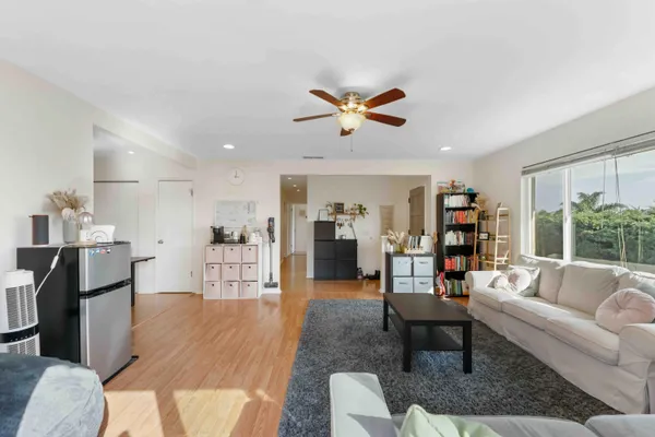 a living room with furniture and a wooden floor