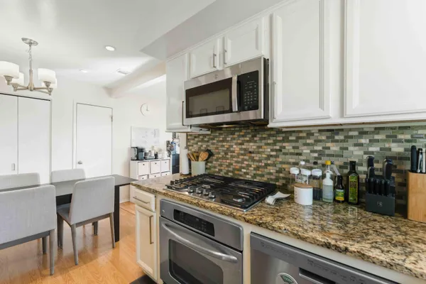 a kitchen with a stove and a microwave