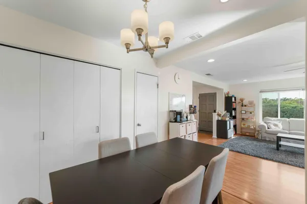 a view of a livingroom with furniture wooden floor and chandelier