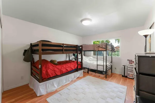 a bedroom with a bed and lamp