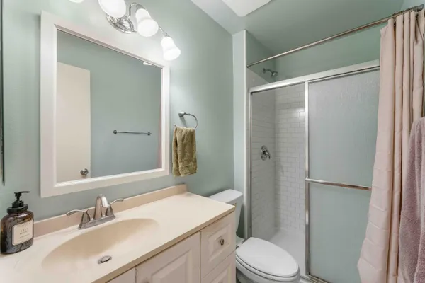 a bathroom with a sink toilet and shower