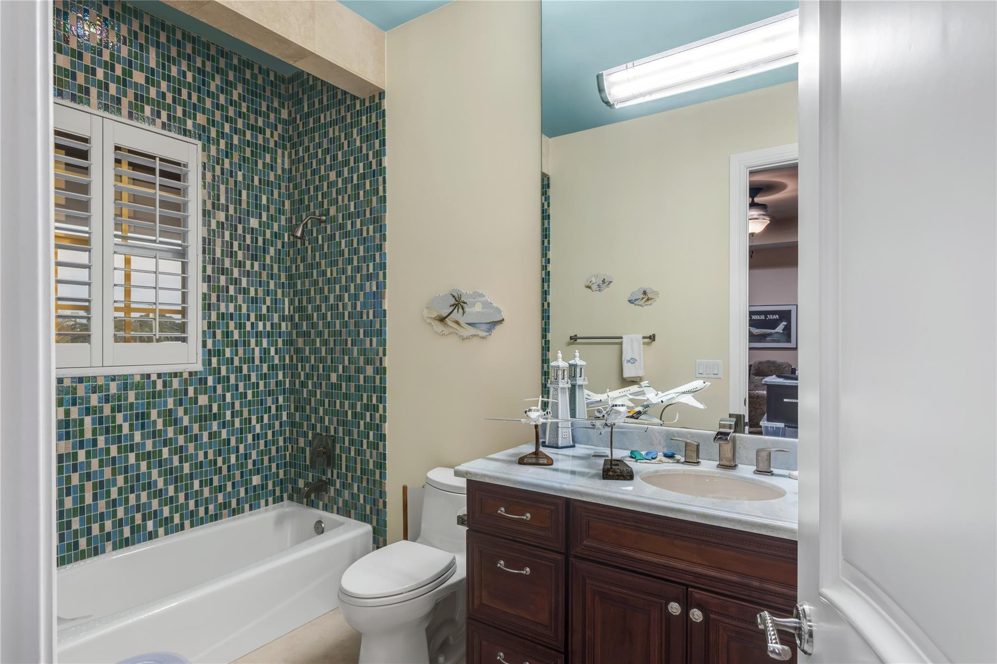 3489 Northeast 30th Avenue Lighthouse Point, FL 33064 - Photo 35 of 42 a bathroom with a sink a toilet and shower