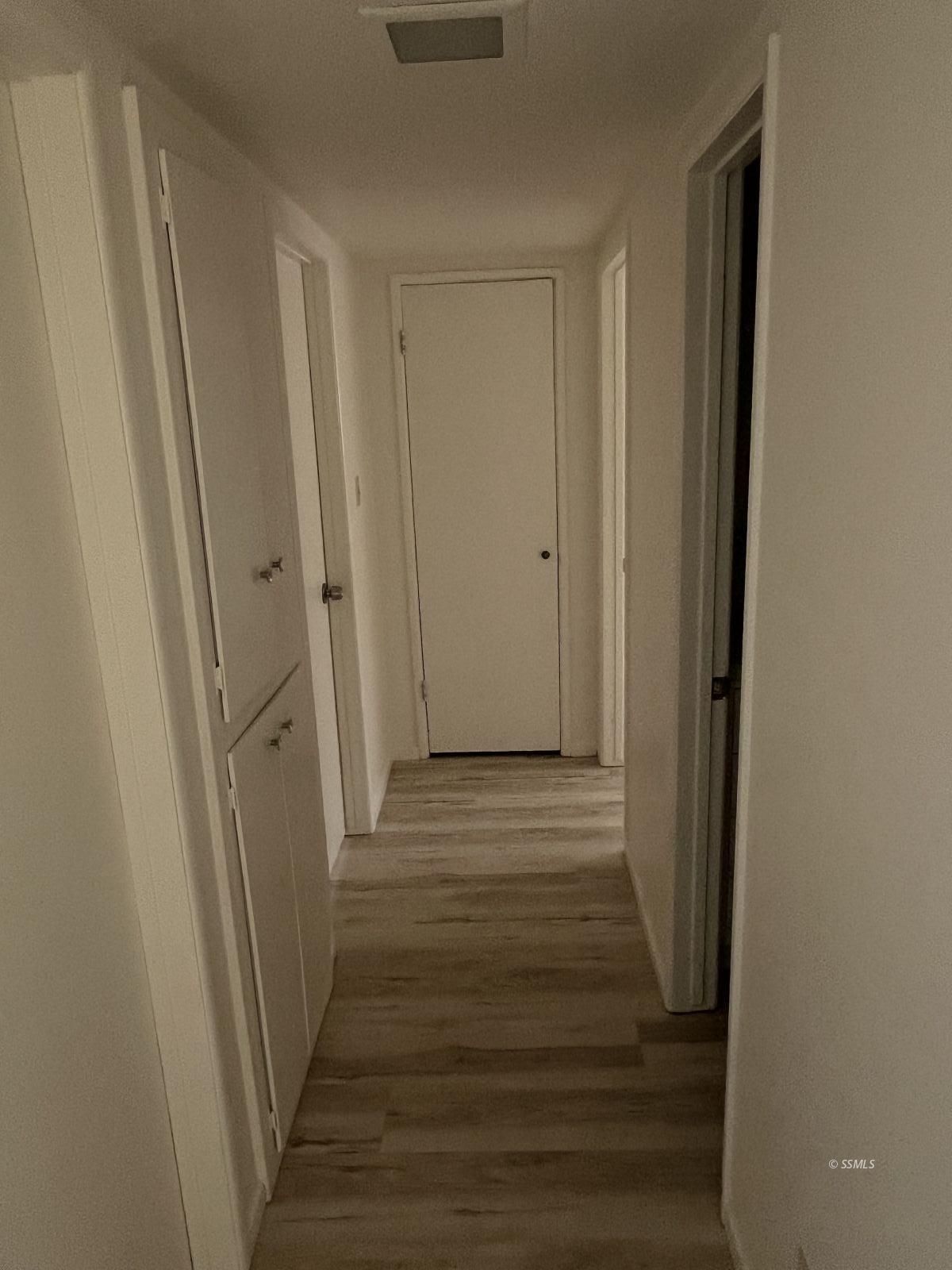 209 South Gold Canyon Street Ridgecrest, CA 93555 - Photo 12 of 33 a view of a hallway with wooden floor