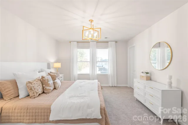 a living room with furniture a mirror and a window