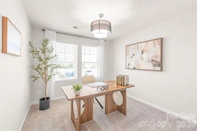 a view of a dining room with furniture and a window