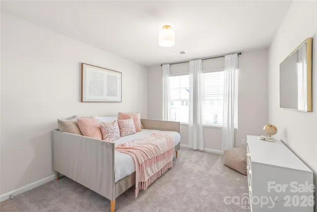 a bed room with a bed and a window